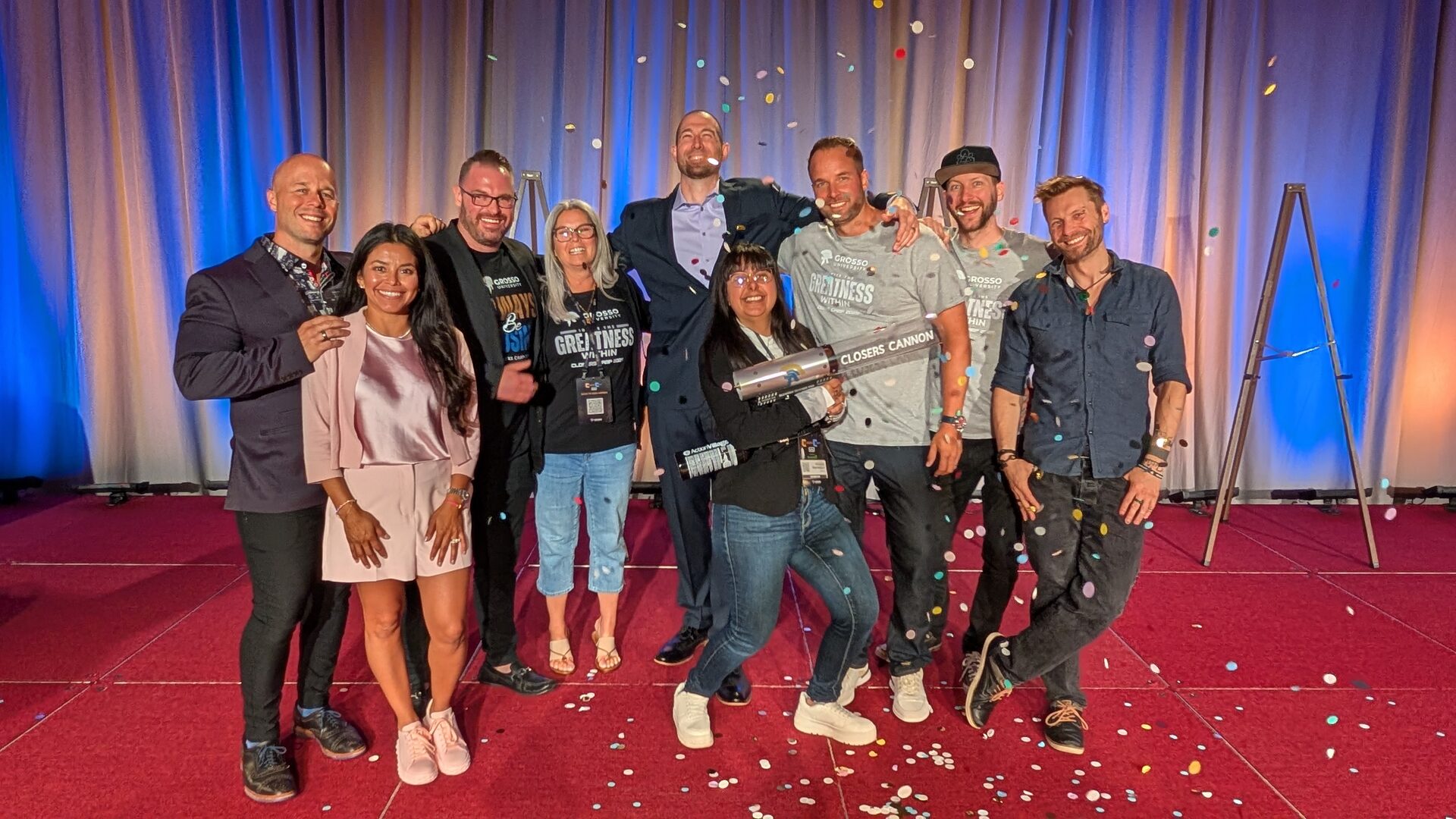 The Grosso University team and the Closers Camp 2025 winners posing together on stage as confetti falls, one attendee holding the Closers Cannon trophy.